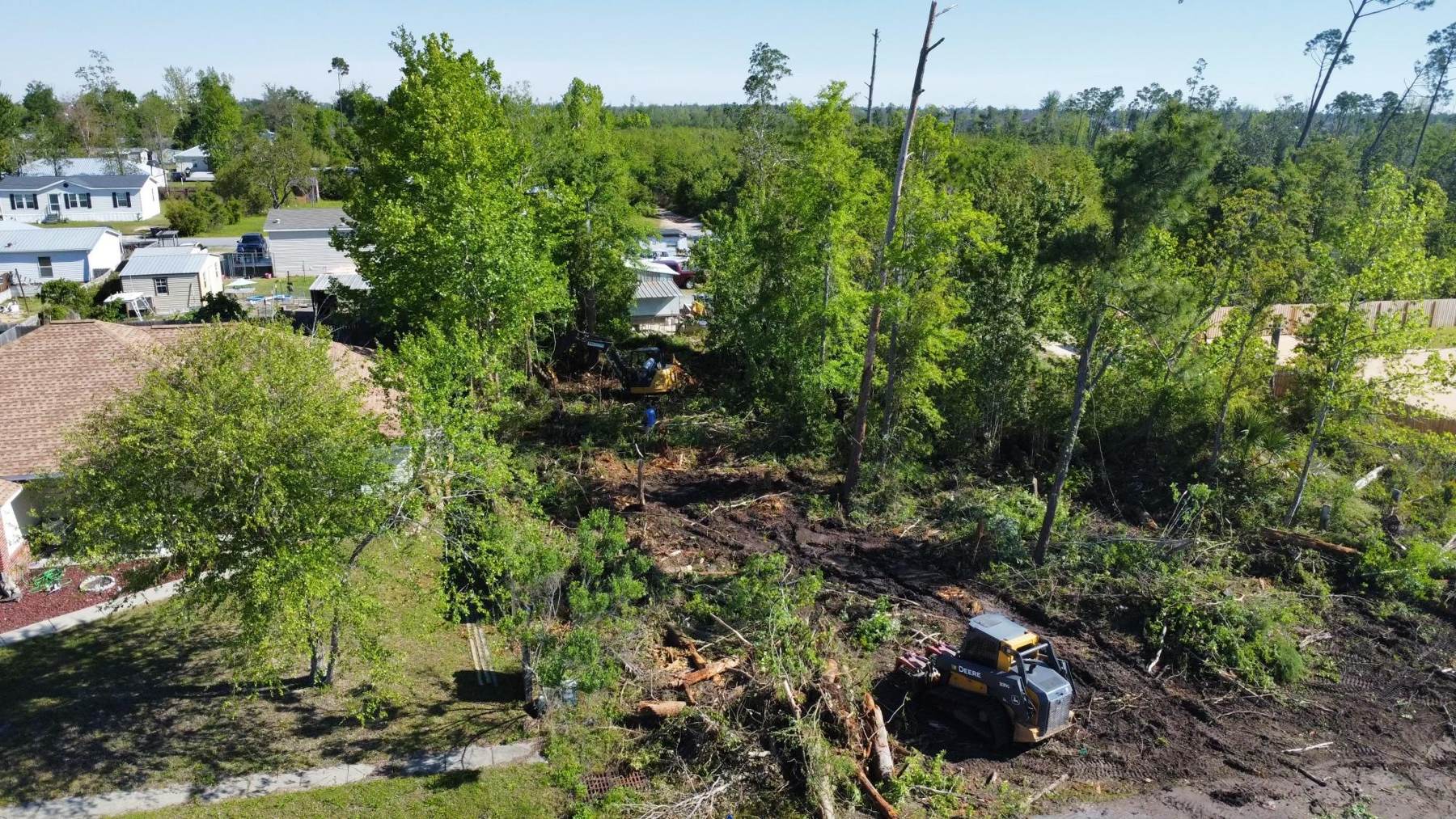 Bradberry Land Management clearing a residential lot with a skid steer and excavator